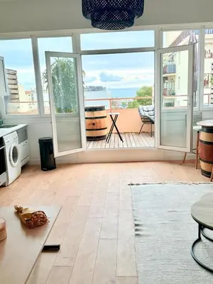a living room with a view of the ocean at Votre COCON Niçois Appart Vue Mer in Nice