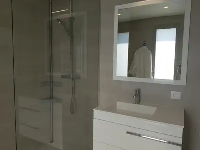 a bathroom with a sink and a shower with a mirror at Laconsolate in Nice