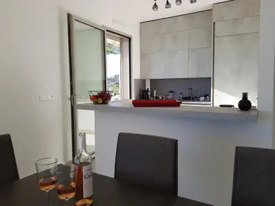 a kitchen with a table with two glasses of wine at Laconsolate in Nice