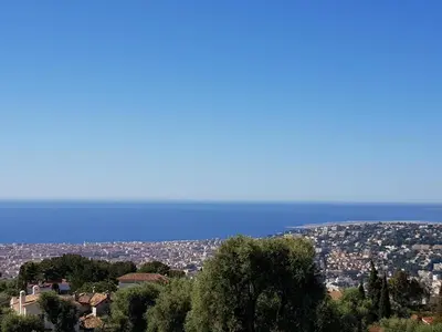 a view of a city with the ocean in the background at Laconsolate in Nice
