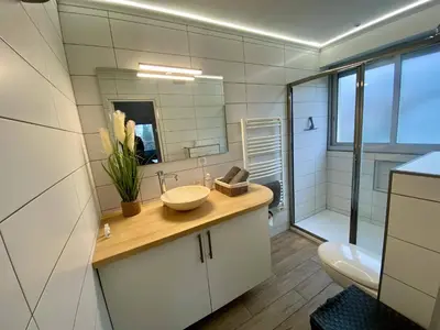 a bathroom with a sink and a toilet and a mirror at F1 Saint Laurent du Var Proximity to beach-Clim Wifi in Saint-Laurent-du-Var
