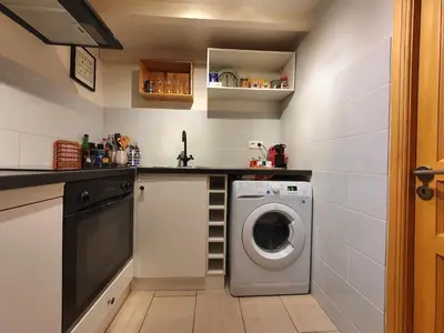 a small kitchen with a washing machine in it at 3 rooms GEM in Old Town Nice in Nice