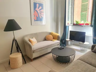 a living room with a couch and a table at 3 rooms GEM in Old Town Nice in Nice