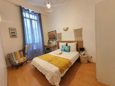 a bedroom with a bed and a chair in it at 3 rooms GEM in Old Town Nice in Nice
