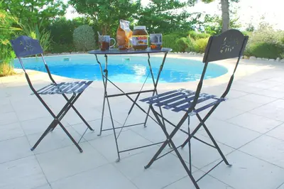 two chairs and a table with food and drinks on it at Proche bord de mer, au calme, nature avec piscine in La Gaude