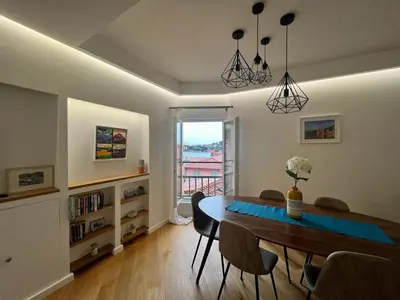 a dining room with a table and chairs and a window at LARA AP4441 By Riviera Holiday Homes in Villefranche-sur-Mer