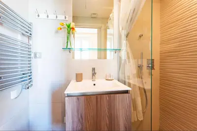 a bathroom with a sink and a glass shower at Studio hyper-centre de Nice in Nice