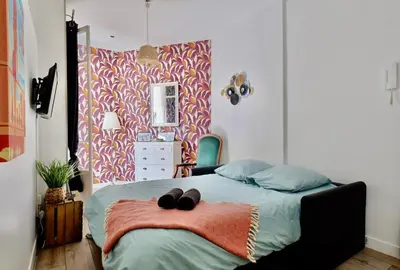 a bedroom with a bed with two black shoes on it at Studio with Big terrace full center with air conditioning in Nice