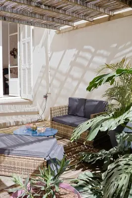 a patio with a blue couch and some plants at Studio with Big terrace full center with air conditioning in Nice