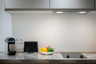 a kitchen counter with a bowl of fruit and a microwave at Le Castelosa - Au coeur du Vieux-Nice in Nice
