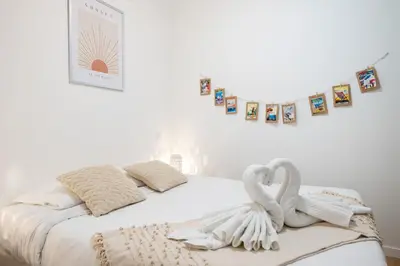 a bedroom with two swans towels on a bed at Le Castelosa - Au coeur du Vieux-Nice in Nice