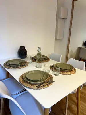 a table with four green plates on top of it at Joli 2 pièces avec terrasse, proche mer in Nice
