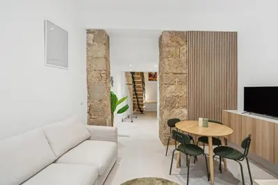 a living room with a white couch and a table at La Promenade Niçoise in Nice