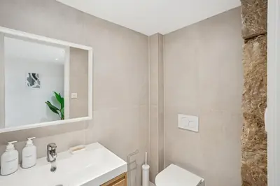 a bathroom with a sink and a toilet and a mirror at La Promenade Niçoise in Nice