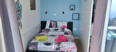 a small bedroom with a bed in a room at Appartement Zen Costa Plana in Cap d'Ail
