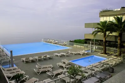 a pool with chaise lounge chairs and a resort at Appartement Zen Costa Plana in Cap d'Ail