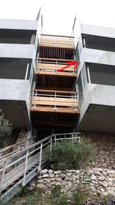 a group of stairs with a red umbrella in a building at Appartement Zen Costa Plana in Cap d'Ail