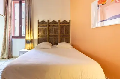 a bedroom with a large bed with two pillows at Proche du Cours Saleya et de la plage, dans le vieux Nice, spacieux et climatisé in Nice