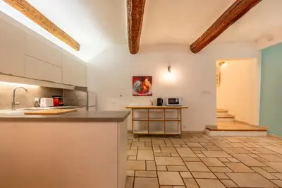 a kitchen with white cabinets and a tile floor at Proche du Cours Saleya et de la plage, dans le vieux Nice, spacieux et climatisé in Nice