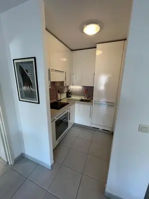 a kitchen with white appliances and a tile floor at Nice Massena 2 rooms in Nice
