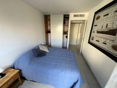 a bedroom with a blue bed in a room at Nice Massena 2 rooms in Nice
