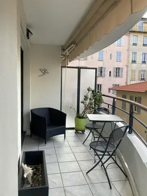 a balcony with a table and chairs on a balcony at Nice Massena 2 rooms in Nice