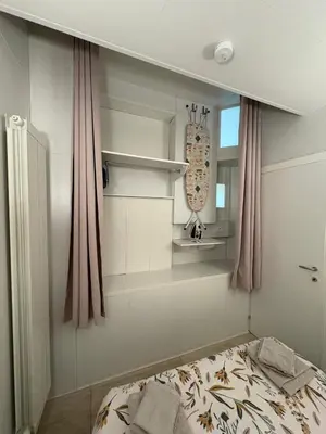 a bedroom with a bed and a mirror and curtains at MUSICIENS Joli DUPLEX 2 Chambres Garage privatif et Terrasse in Nice
