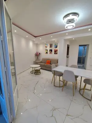 a living room with a table and chairs and a couch at Cozy appartment downtown Nizza 2 Bedroom 1 min Beach 1 min tramway 10min airport air conditionner in Nice
