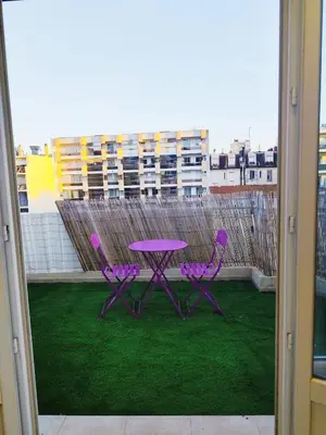 a purple table and two purple chairs on a balcony at Cozy appartment downtown Nizza 2 Bedroom 1 min Beach 1 min tramway 10min airport air conditionner in Nice
