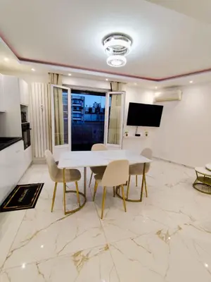 a dining room with a white table and chairs at Cozy appartment downtown Nizza 2 Bedroom 1 min Beach 1 min tramway 10min airport air conditionner in Nice