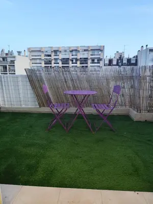 a purple table and two purple chairs on the grass at Cozy appartment downtown Nizza 2 Bedroom 1 min Beach 1 min tramway 10min airport air conditionner in Nice