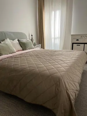 a bedroom with a large bed with a blanket at Appartement d'exception vue mer Nice Blue Pearl in Nice