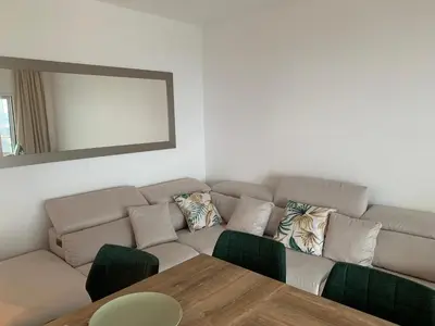 a living room with a couch and a table at Appartement d'exception vue mer Nice Blue Pearl in Nice