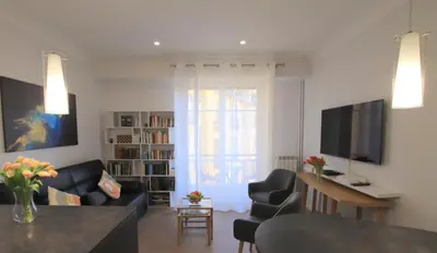 a living room with a couch and a table at La Suite Liberation in Nice