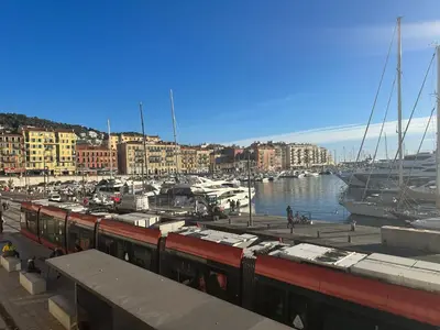 a train at a marina with boats in the water at Estudio 20 m2 in Nice