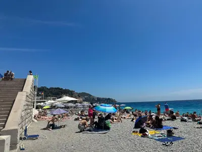 a group of people sitting on a beach at Estudio 20 m2 in Nice