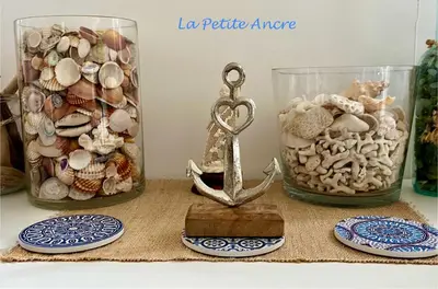 a table with two glass jars filled with shells at La Petite Ancre in Beaulieu-sur-Mer