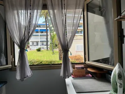 a window with a view of a building at La Petite Ancre in Beaulieu-sur-Mer