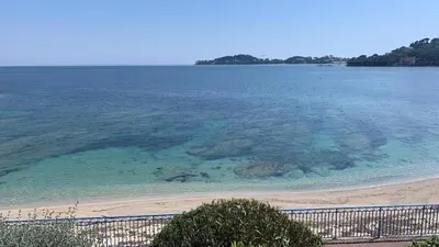 a view of a beach and the ocean at La Petite Ancre in Beaulieu-sur-Mer