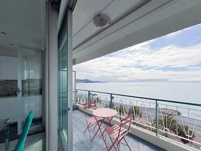 a balcony with a table and chairs and the ocean at Promenade des Anglais - Vue Mer, AC, 2pers in Nice