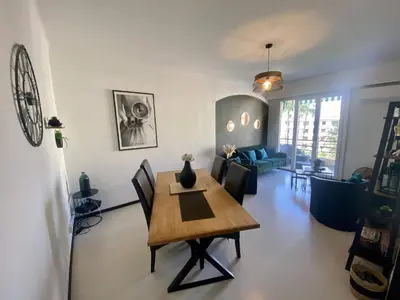 a living room with a wooden table and chairs at Nice Ouest Caucade- Beautiful 2P, AC, Clim in Nice