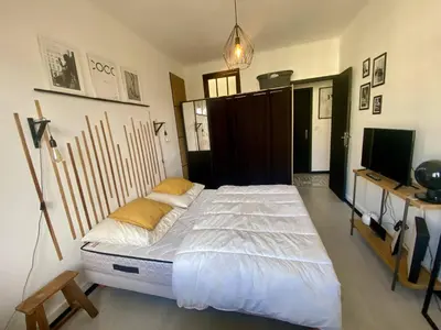 a large bed in a room with a television at Nice Ouest Caucade- Beautiful 2P, AC, Clim in Nice