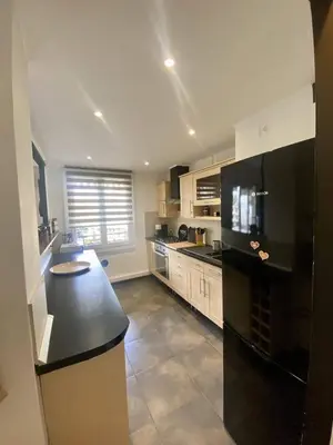 a large kitchen with a black counter top in it at Nice Ouest Caucade- Beautiful 2P, AC, Clim in Nice