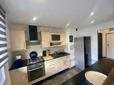 a kitchen with white cabinets and a black counter top at Nice Ouest Caucade- Beautiful 2P, AC, Clim in Nice