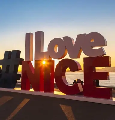 a large sign that reads love hate in front of the ocean at Beautiful & cosy appart, calme et lumineux in Nice