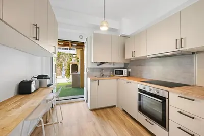 a kitchen with white cabinets and a counter top at Maison de ville familiale, 5 chambres, terrasse, à 20 minutes du centre ville in Nice