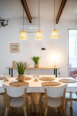 a dining room with a white table and chairs at Maison de ville familiale, 5 chambres, terrasse, à 20 minutes du centre ville in Nice