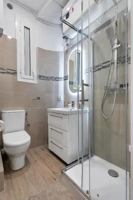 a bathroom with a toilet and a glass shower at Nice Renting - HONORE - Elegant apartment near Promenade des Anglais in Nice