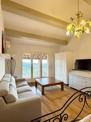 a living room with a couch and a table at Magnifique Studio Cagnes Sur Mer in Cagnes-sur-Mer