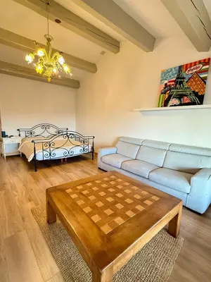 a living room with a couch and a chess board on a table at Magnifique Studio Cagnes Sur Mer in Cagnes-sur-Mer